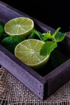 Lime with mint on rustic background Stock Photos