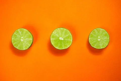 Lime on the orange background Stock Photos