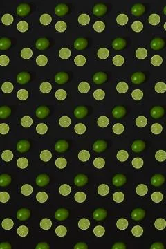 Lime pattern on black background. Minimal flat lay concept. Stock Photos