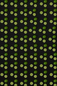 Lime pattern on black background. Minimal flat lay concept. Stock Photos