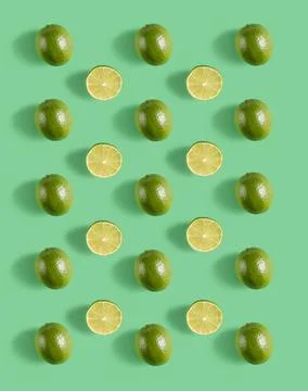 Lime pattern with hard shadow on a green background, top view. Stock Photos