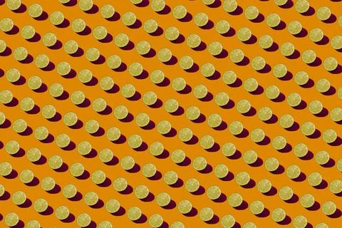 Lime pattern on a orange background. Pop art design, creative citruses. Yellow Stock Photos