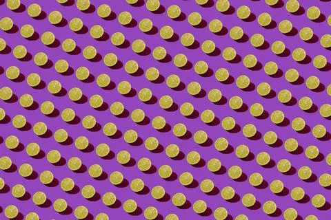 Lime pattern on a purple background. Pop art design, creative citruses. Yellow Stock Photos