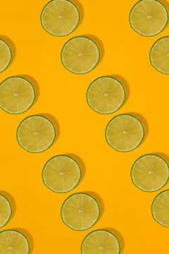Lime pattern on yellow background. Minimal flat lay concept. Stock Photos