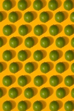 Lime pattern on yellow background. Minimal flat lay concept. Stock Photos