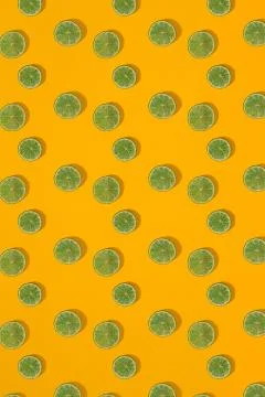 Lime pattern on yellow background. Minimal flat lay concept. Stock Photos