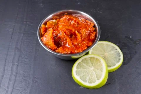 Lime pickle with lime slices on slate background Stock Photos