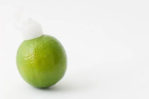 Lime with a plastic nozzle on one end Stock Photos