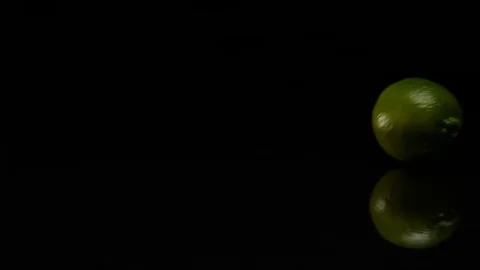 Lime rolls out on a black table Video stock 80605549