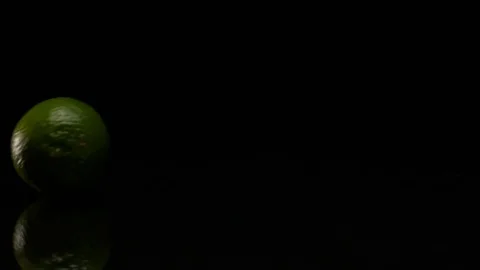 Lime rolls out on a black table Video stock 80606008