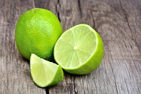 Lime on rustic table Stock Photos