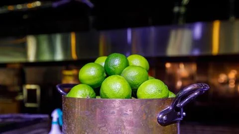Lime in a saucepan, muted dark background Stock Photos