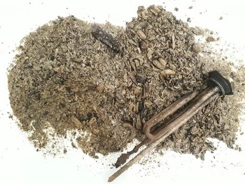 Lime scale on the heating element. Anode with scum from the boiler for water. Stock Photos