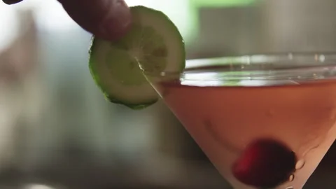 Lime slice is added to martini drink Stock Footage 274627951