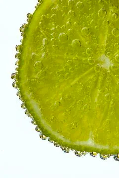 Lime Slice Covered in Bubbles Stock Photos