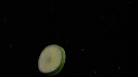 Lime Slice Falling into Water Super Slowmotion, Black Background, lots of Stock Footage 145809906