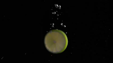 Lime Slice Falling into Water Super Slowmotion, Black Background, lots of Stock Footage 145809957
