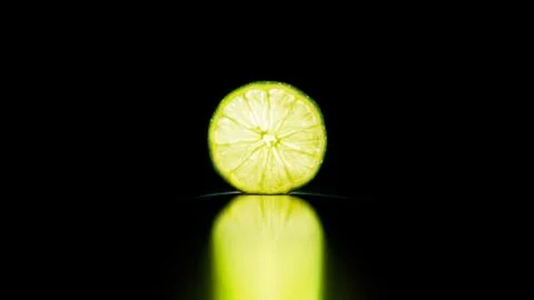 Lime slice isolated in the black Stock Photos