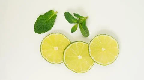 Lime slice with mint leaves isolate on white. Foto stock