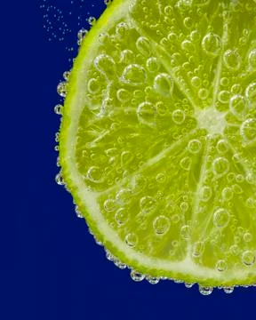 Lime Slice in Sparkling Water Stock Photos