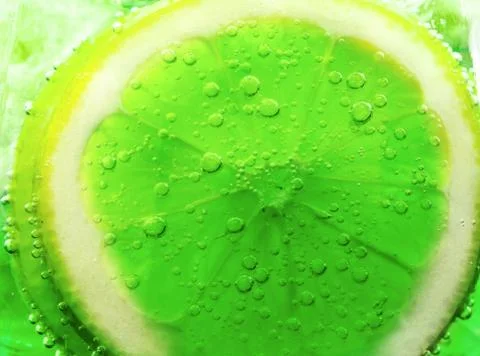 Lime slice in water bubbles Stock Photos