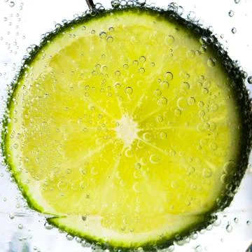 Lime slice in water Stock Photos