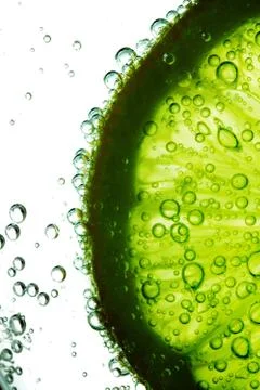 Lime slice in water Stock Photos