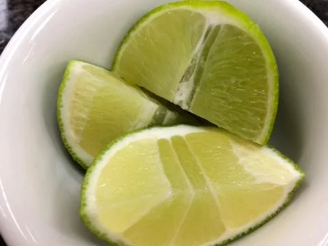 Lime slice in white bowl Stock Photos