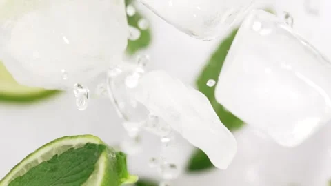 Lime slices and mint leaves flying up, mojito concept. Exploding water drop.. Stock Footage 309124018