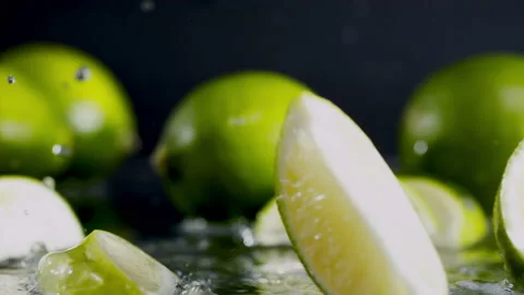 Lime slices fall into the water on yellow background Super slow-mo 1000 fps Stock Footage 163959441