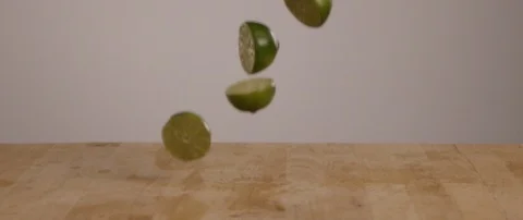 Lime Slices Falling Onto Cutting Board 스톡 동영상 105377487