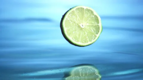 Lime slices falling into water Stock Footage 8572566