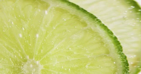 Lime slices falling in water Stock Footage 101601013