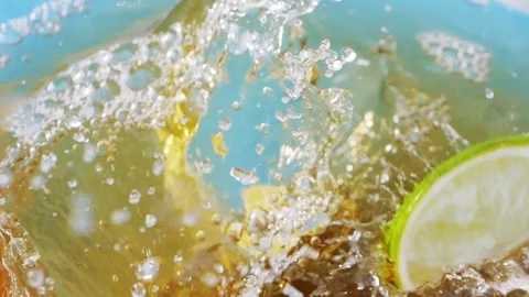 Lime slices splashing into iced tea, creating bubbles Stock Footage 287697730