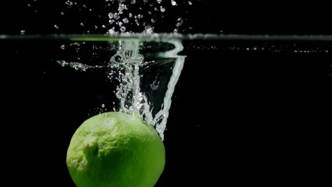 Lime splashing into water on black background closeup in super slow motion Stock Footage 117014474