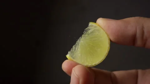 A lime squeezed in slow motion. Juicy lemon is squeezed vitamin C Video stock 137433329
