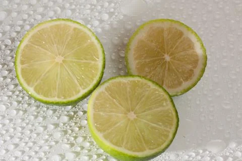 Lime with water drops Stock Photos