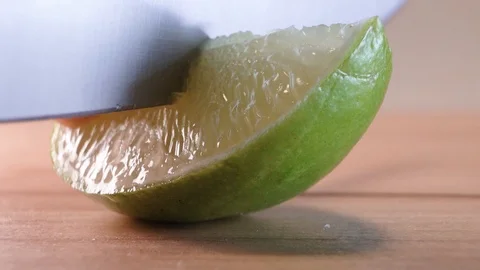 Lime wedge cutting macro slow motion Stock Footage 124443305