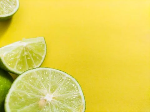 Lime on yellow background Stock Photos
