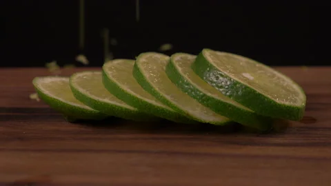 Lime Zest Falling on Lime slices 스톡 동영상 131007219