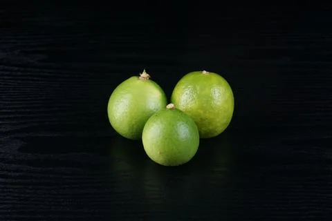 Limes on a black table Stock Photos
