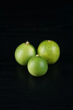 Limes on a black table Stock Photos
