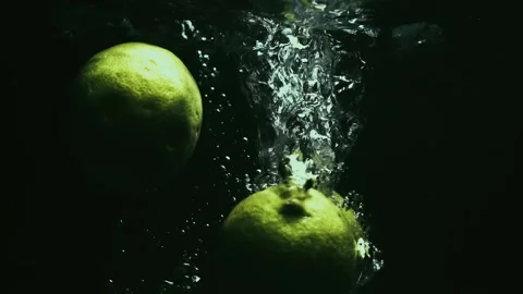 Limes Drop and Splash in Slow Motion Stock Footage 300892612