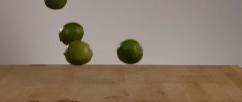 Limes Falling Onto Cutting Board In Slow Motion 스톡 동영상 105373456