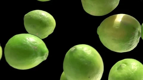 Limes falling down on the black background Stock Footage 274744073