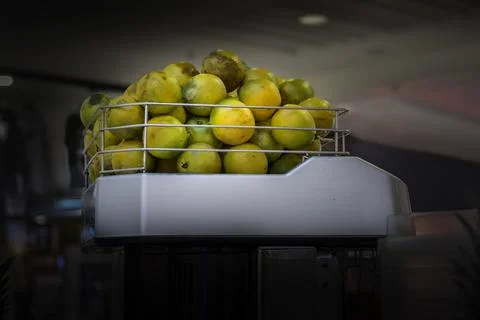 Limes in Juicing Machine Stock Photos