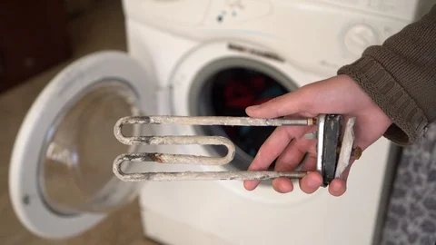 Limescale on the heating element for washing machine Stock Footage 123061848