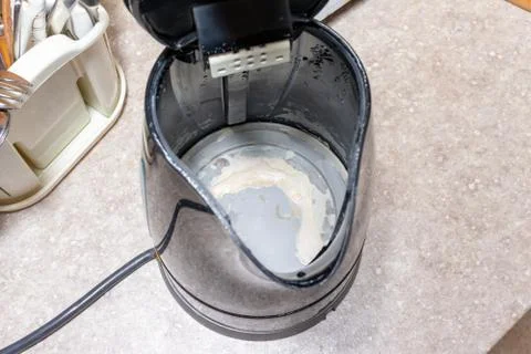 Limescale, lime scale in old kettle in kitchen. A white, chalky residue of ca Stock Photos