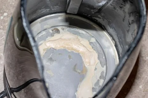 Limescale, lime scale in old kettle in kitchen. A white, chalky residue of ca Stock Photos