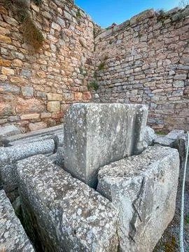Limestone Blocks Stack Powerfully Against Ochre Ruin Walls 스톡 사진